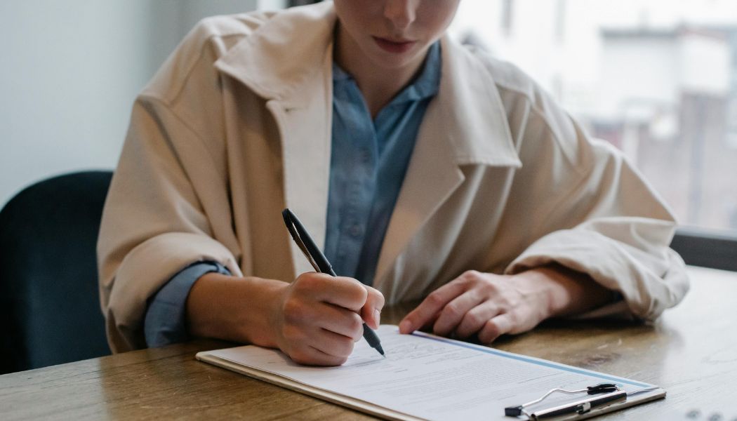 Man filling out an ADHD assessment form during a diagnostic session.