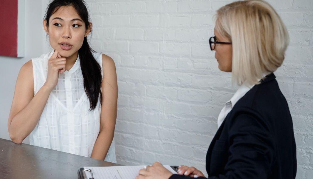 Woman talking to a therapist across a desk.